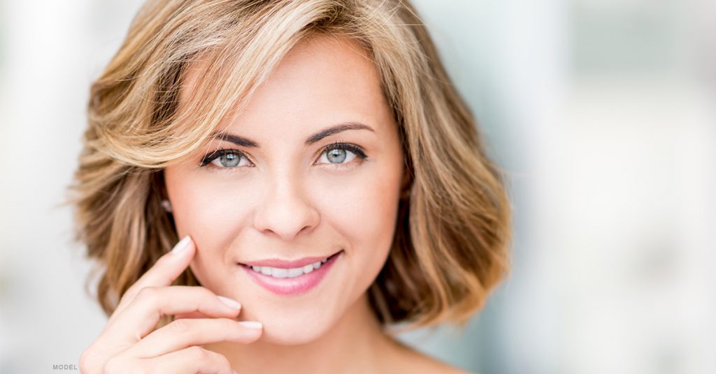 Woman showing off her skin after a laser skin treatment.